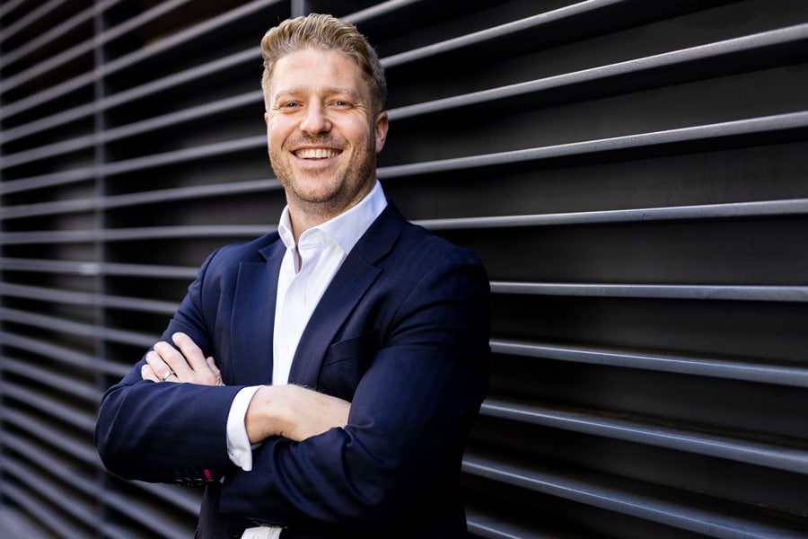 Martin Hartley in front of a dark wall