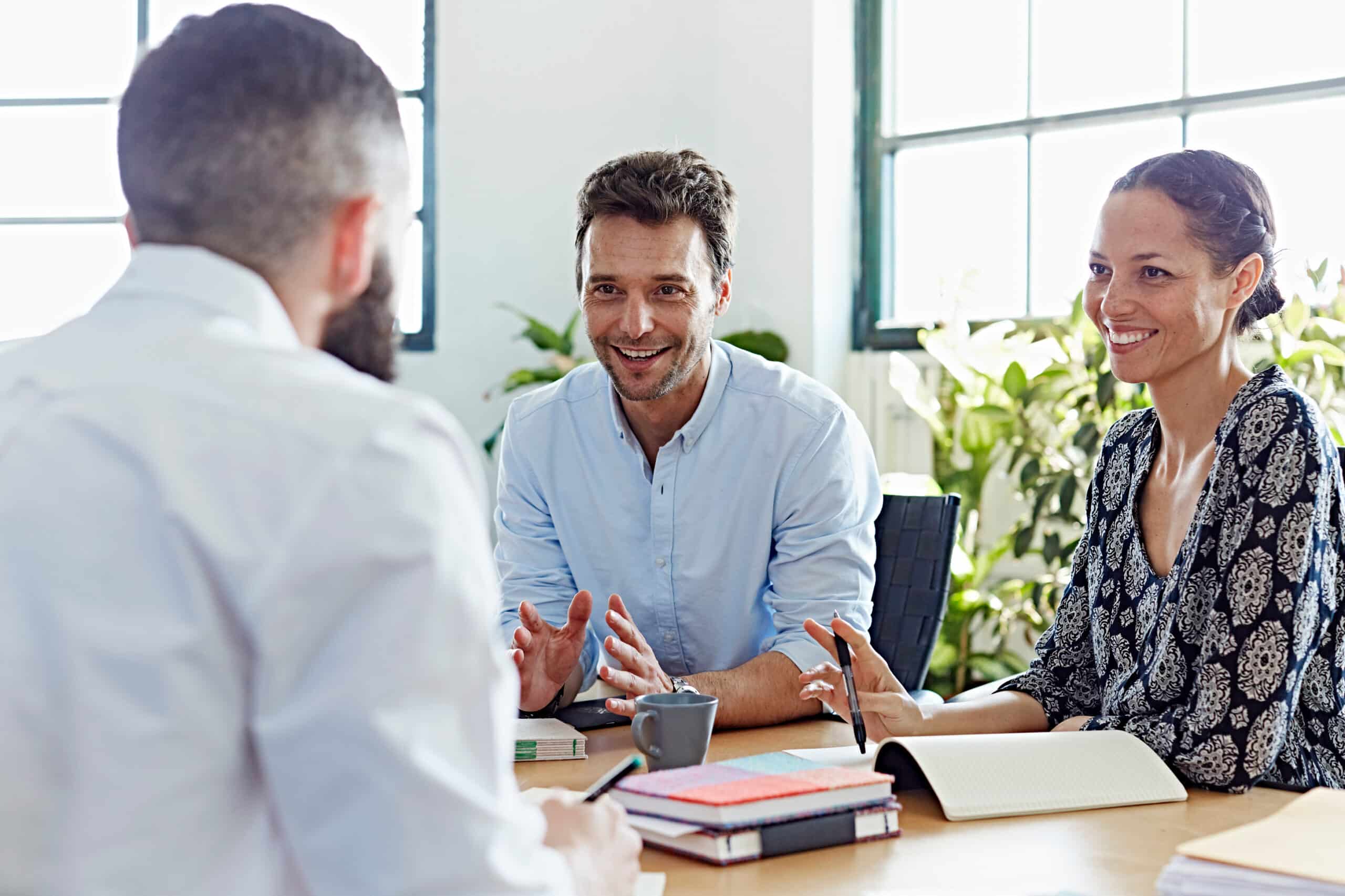 Business people having a discussion at desk in office.